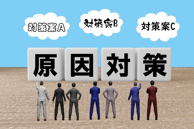原因対策の文字ブロックをみるビジネスマン